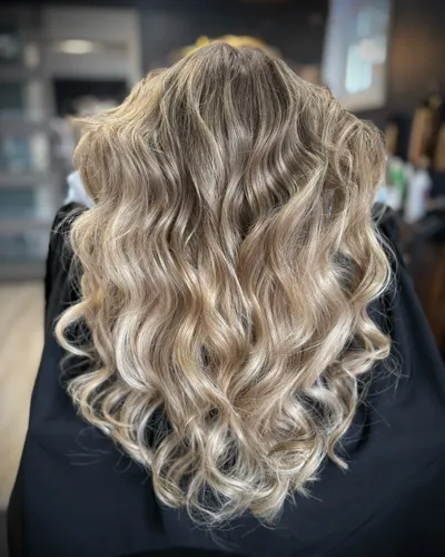 Warm dimensional balayage with voluminous curls — back view