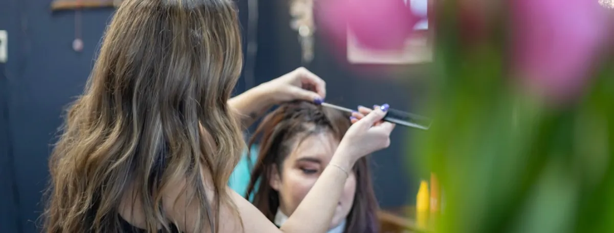 Maria styling a client's hair in the salon