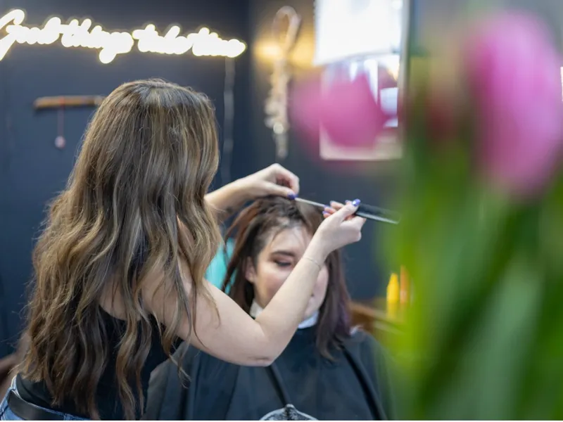 Maria working hands-on with a client in the salon